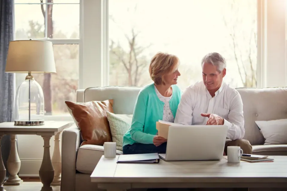 Couple Sat on a Sofa with a Laptop
